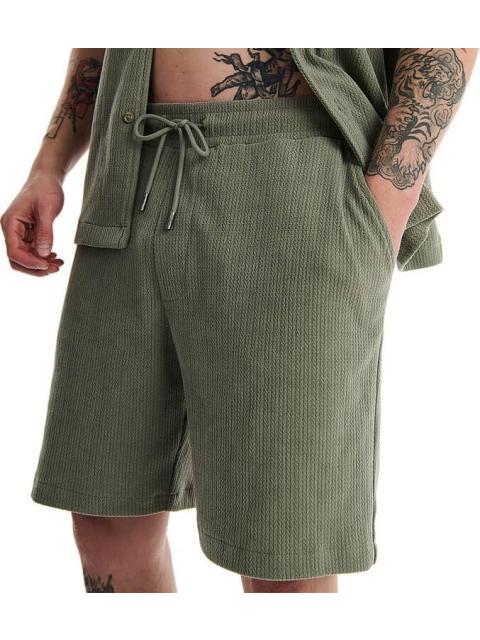 SHORT BASICO VERDE OLIVO NEXT CO - Imagen 4